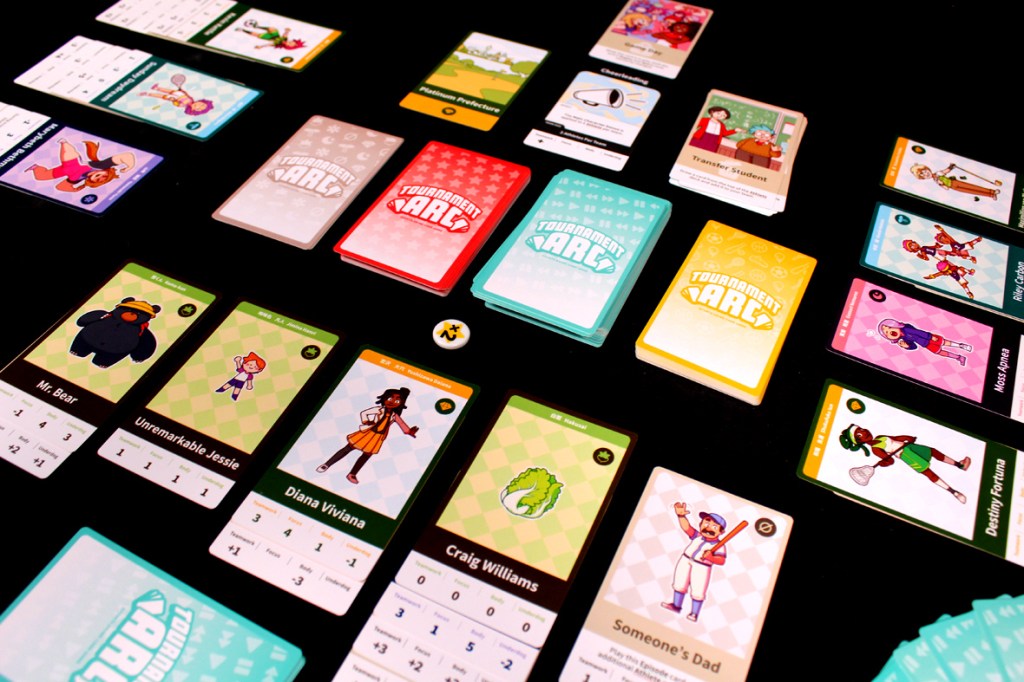 A tabletop game setup for 'Tournament Arc,' featuring various character and episode cards arranged on a black surface, showcasing vibrant artwork and game components.