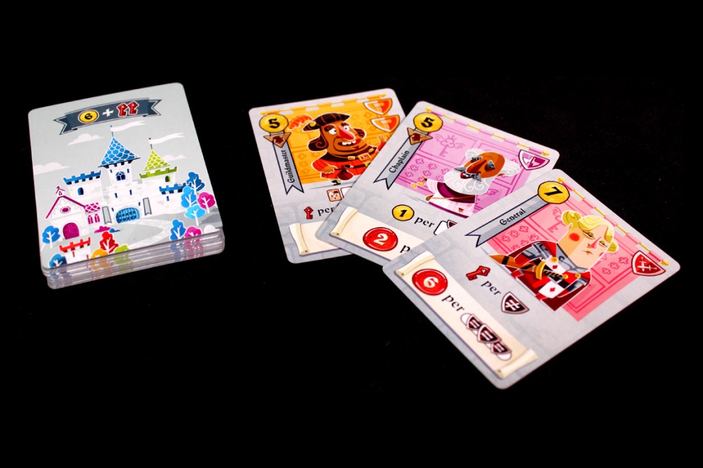 A set of card game components featuring a bundle of Castle cards on the left with a colorful castle illustration, and three character cards on the right, each displaying unique characters and values, all set against a black background.