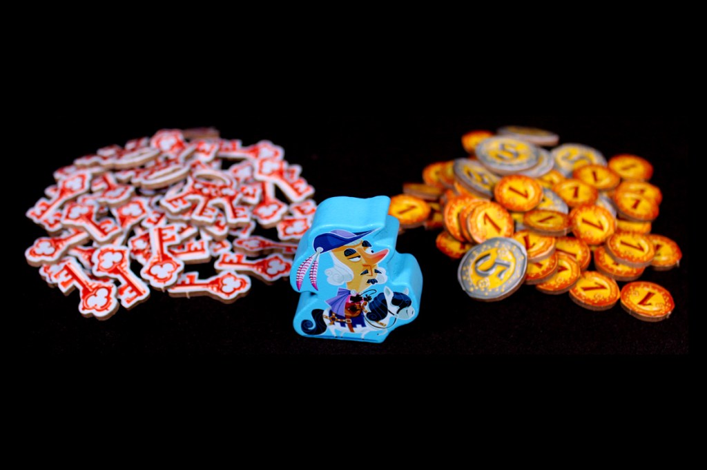 A collection of game components for Castle Combo, featuring a pile of red key tokens, a blue messenger pawn character, and a stack of gold coin tokens.