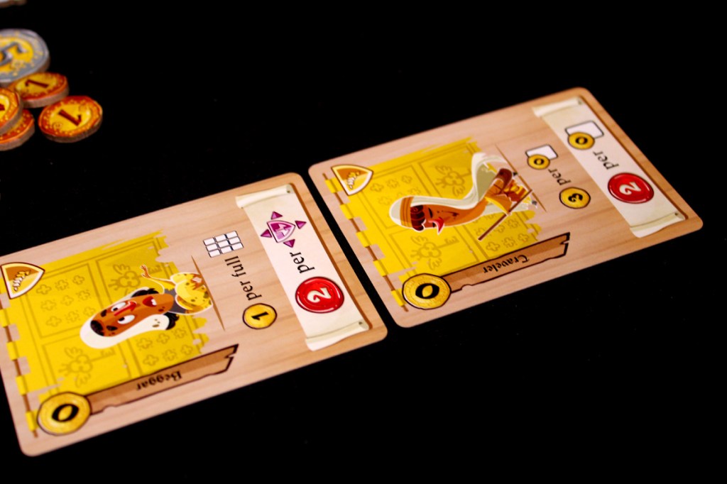 Two game cards from Castle Combo displayed on a black background. One card features a character with a dish, while the other shows a character with an instrument, both including icons and scoring details.