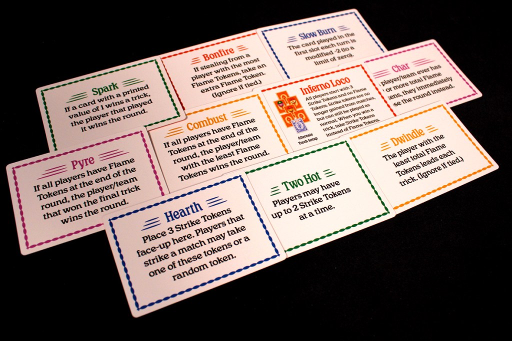 A collection of game cards featuring various abilities and rules for gameplay, including 'Spark', 'Bonfire', 'Combust', and others, all displayed against a black background.