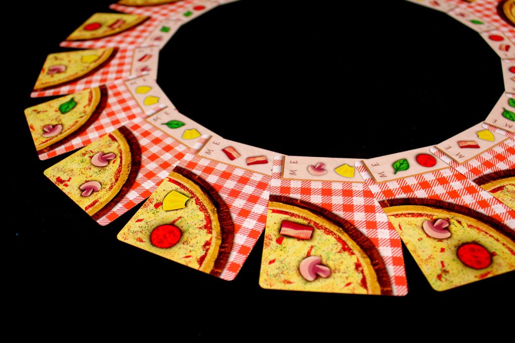 A circular arrangement of pizza slices and menu cards laid out on a black background, showcasing various toppings like pepperoni, mushrooms, and green leaves.