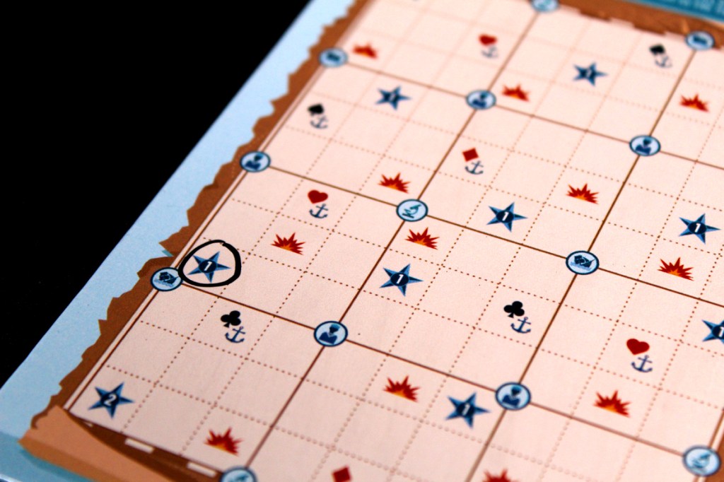 Close-up of a player board for the game Flip Voyage, showing a grid with various icons including stars, hearts, anchors, and fire explosions.