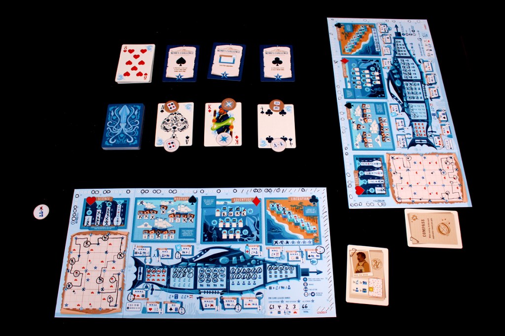 A tabletop game layout featuring player boards, cards, and tokens in a nautical theme for the game Flip Voyage.