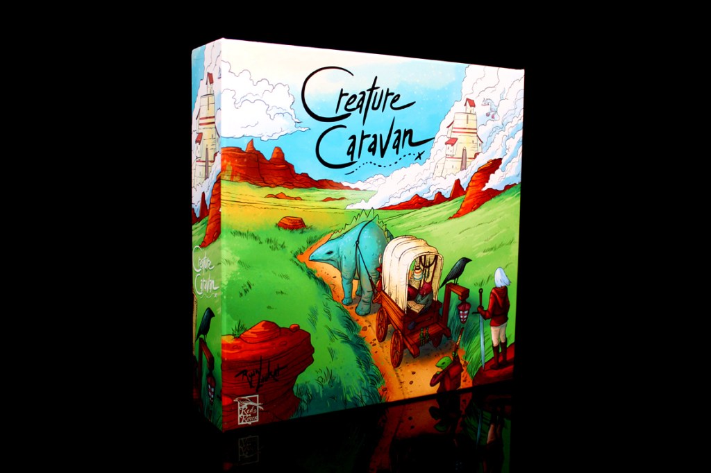 The box of the board game 'Creature Caravan' featuring colorful artwork of characters and a landscape with rolling hills and clouds.