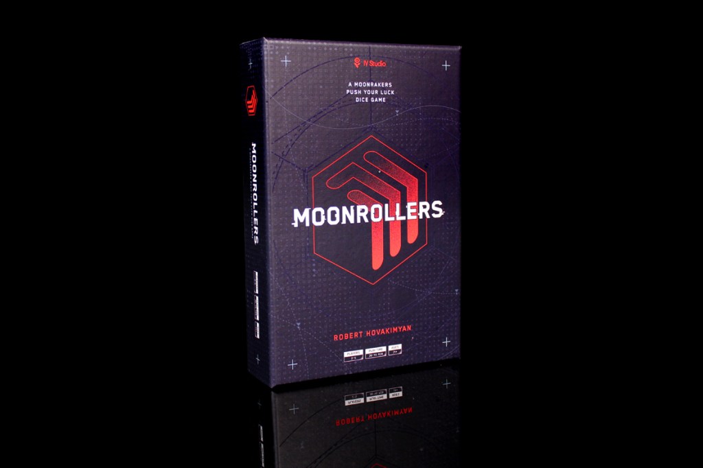 A box of the board game Moonrollers featuring a sleek design with a hexagonal logo, set against a dark background.