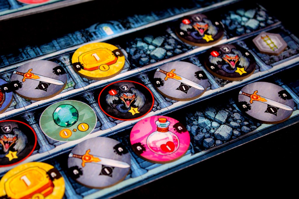 Game components for Satchel Quest showing various tokens, including weapons, gems, and health potions arranged on a game board.