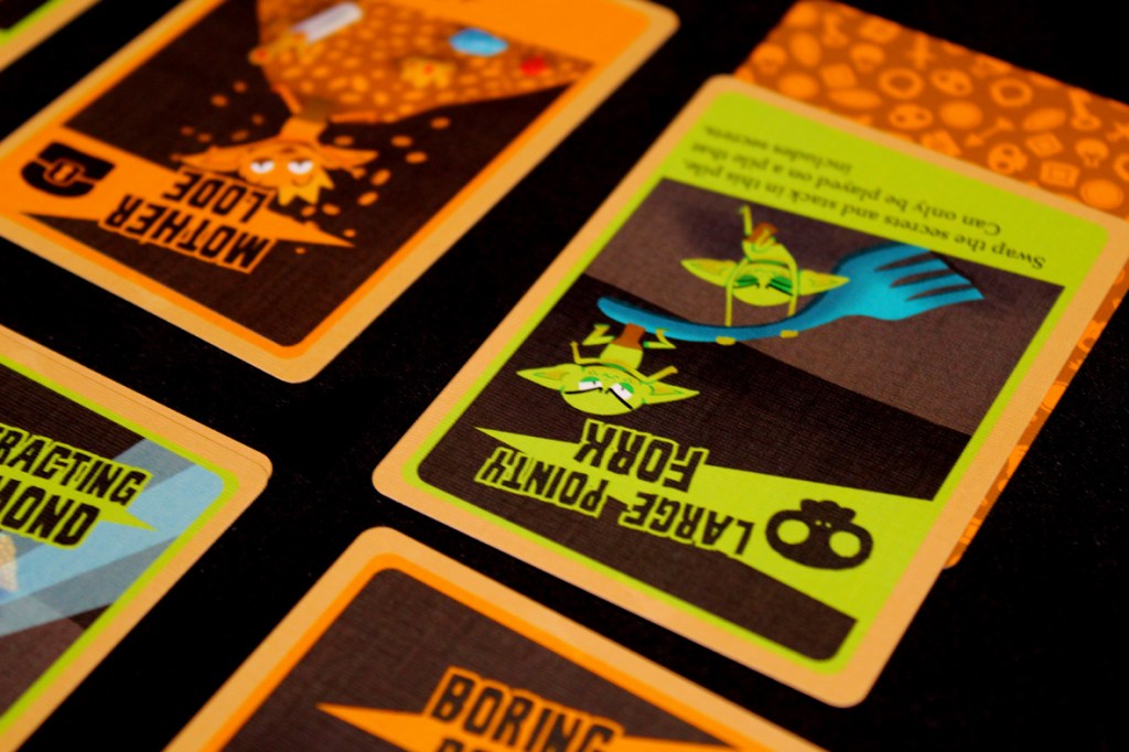 Close-up of game cards from the board game 'Squabblin Goblins', featuring colorful illustrations of goblins and gameplay effects.