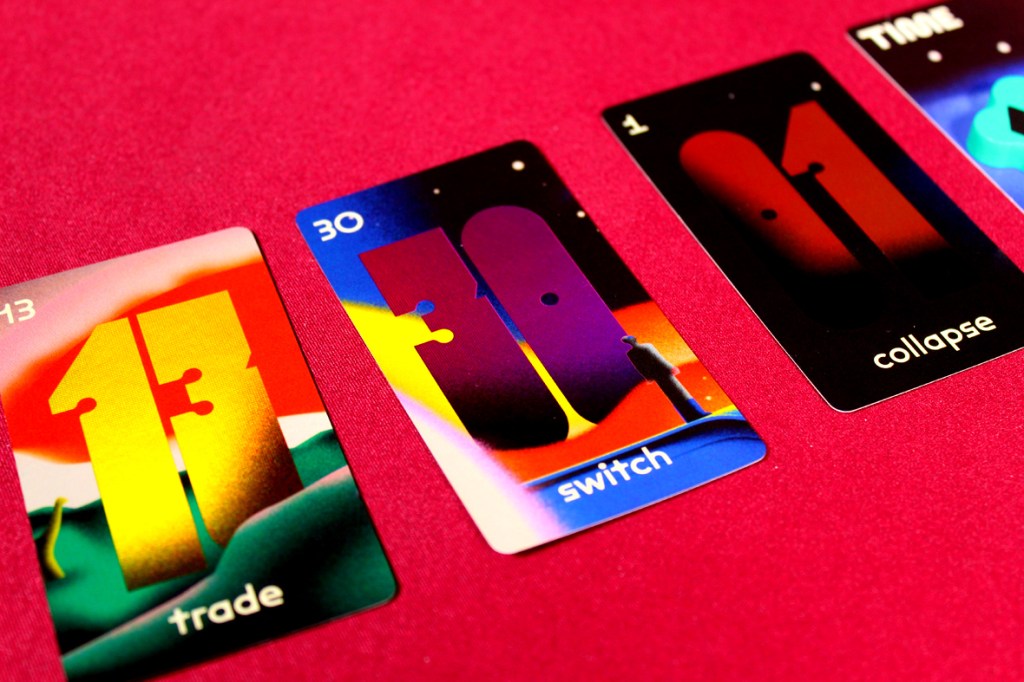 Colorful game cards from the board game Time to Panic, displaying action names such as 'trade', 'switch', and 'collapse', with vibrant abstract backgrounds.