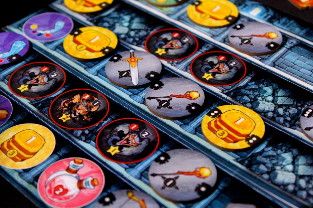 Close-up view of game tokens and components from the board game 'Satchel Quest', featuring various items such as swords, potions, and treasure chests laid out on a dungeon-themed board.
