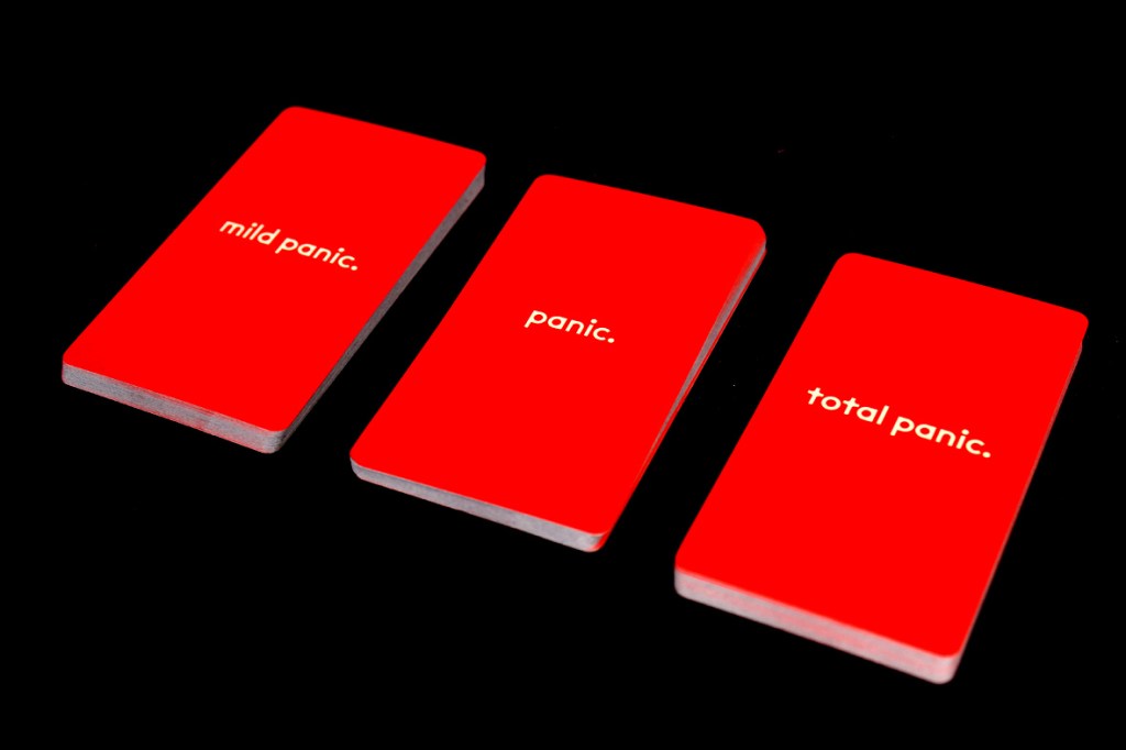 Three game cards labeled 'mild panic,' 'panic,' and 'total panic' on a black background.