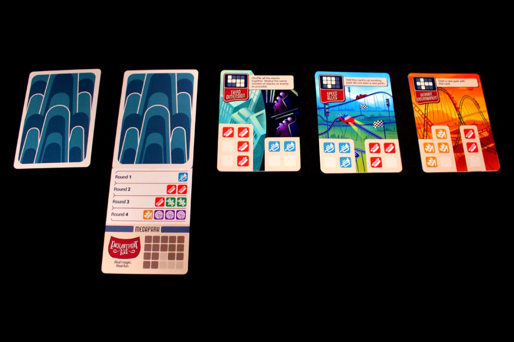 Image of game components for 'Lands of Amazement', featuring Megapark Cards and Park Cards laid out on a black background.
