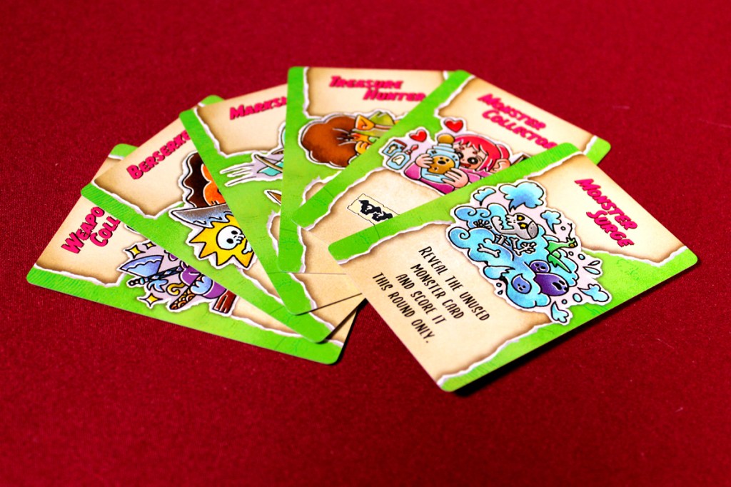A selection of colorful game cards featuring various whimsical characters and items, displayed against a red background.