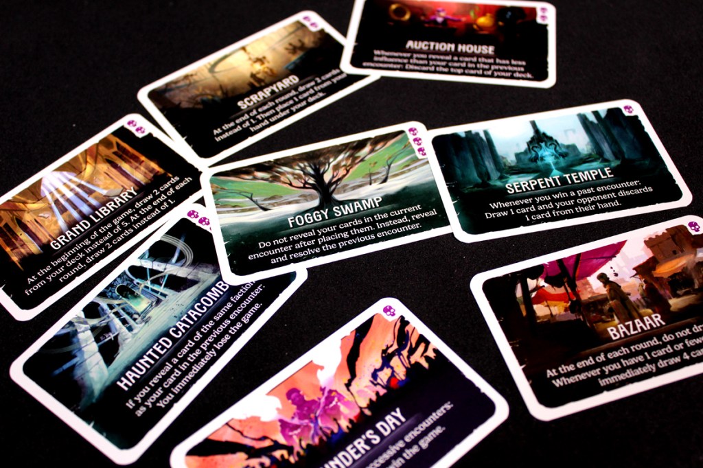 A spread of cards from the game Duel for Cardia, featuring titles like 'Grand Library', 'Scrapyard', and 'Foggy Swamp', displayed on a dark background.