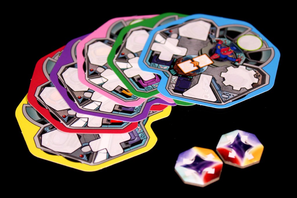 A collection of colorful game boards and tokens related to the board game 'Crash & Grab', featuring various colors and design elements.