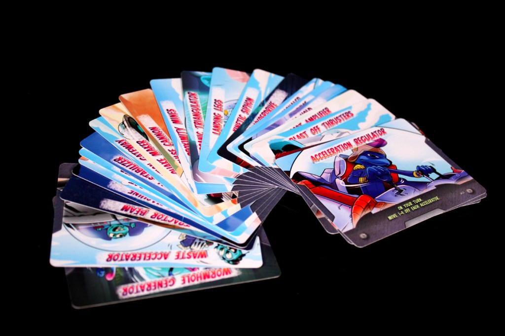 A fan of movement cards from the board game 'Crash & Grab', featuring colorful illustrations and text indicating various gameplay actions.