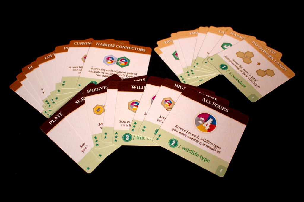 A collection of gameplay cards from the board game Cascadia: Alpine Lakes, featuring various scoring rules and wildlife types presented on a black background.