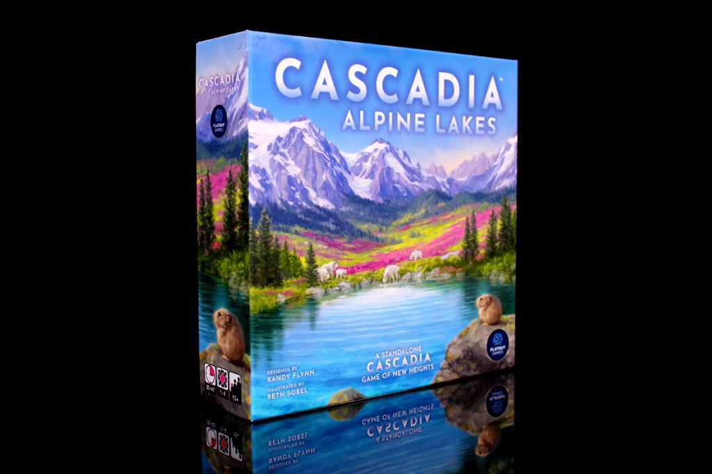 A box of the board game 'Cascadia: Alpine Lakes' featuring vibrant mountain scenery, colorful flowers, and two small animals by a lake.