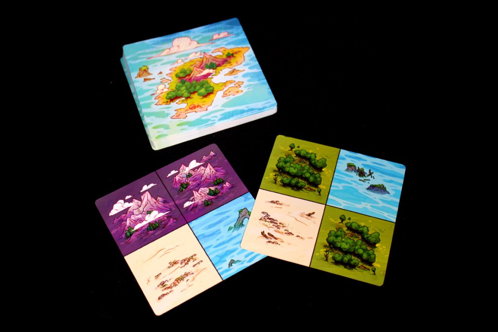 An assortment of game tiles and a top card featuring a colorful island landscape, showcasing various terrains including mountains, forests, and bodies of water.