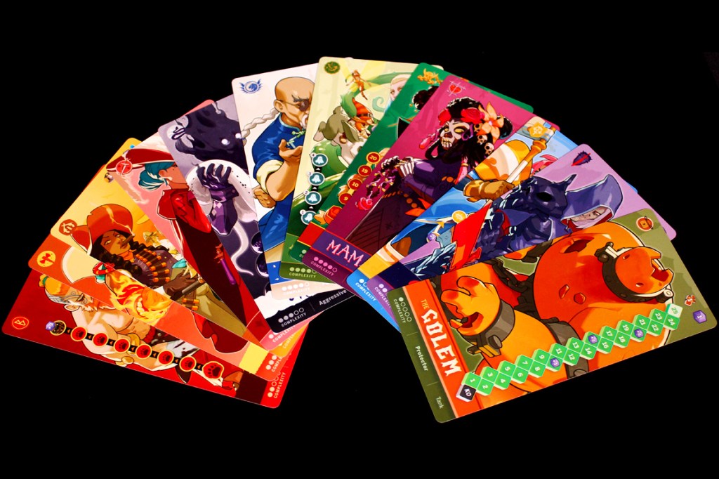 A colorful array of character cards from the game Tag Team, showcasing diverse designs and artwork, laid out on a black background.
