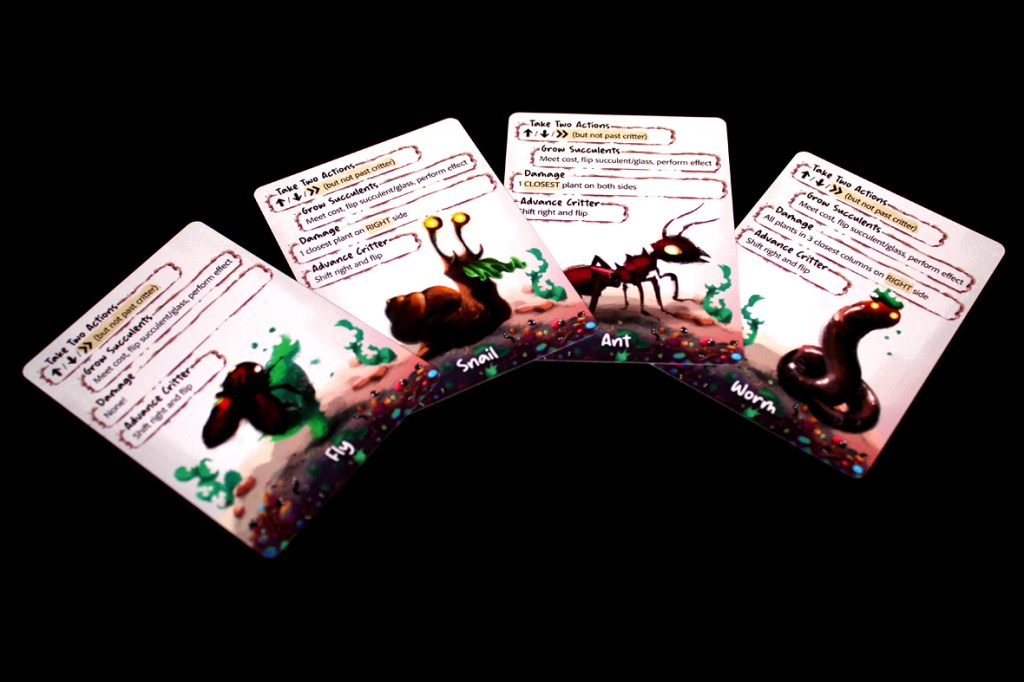 Four illustrated game cards from Glass Garden featuring a Fly, Snail, Ant, and Worm, each with gameplay instructions.