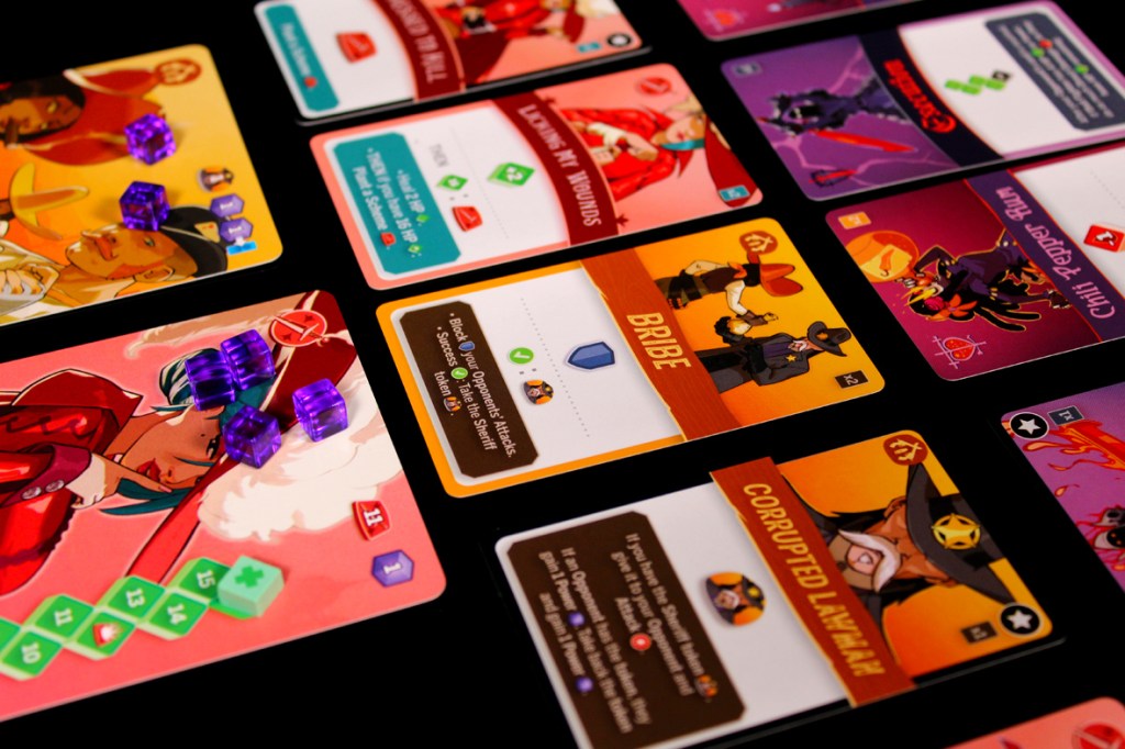 A tabletop game setup featuring various character cards and action cards with purple tokens on the playing area, showcasing elements of gameplay for a strategic card game.