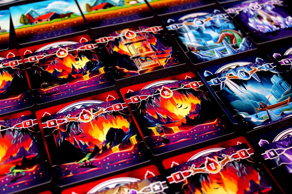 A colorful layout of game cards from the board game 'Tranquility: The Descent', featuring various illustrations of underground landscapes, including flames, caves, and other elements. The cards are arranged in a grid pattern, showing numbers ranging from 0 to 18.