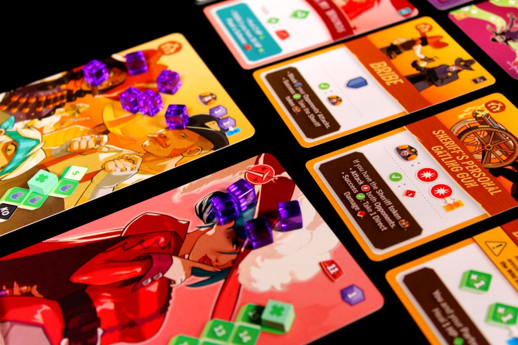 Close-up of character cards and action tokens from a two-player board game, featuring colorful illustrations and clear symbols.