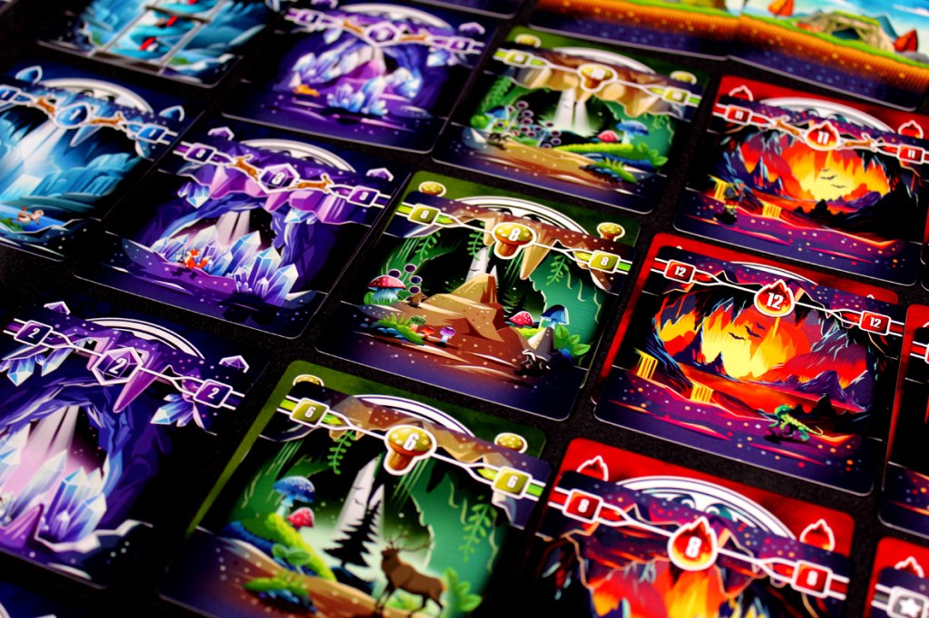 A colorful, vibrant assortment of cards displaying various underground landscapes, including caves, crystals, and wildlife, set in a grid layout.