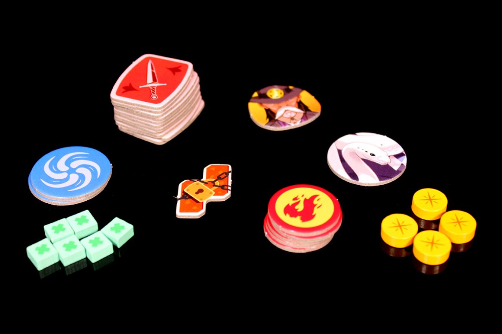 An assortment of game tokens and markers, including health tokens, character ability symbols, and action tokens, arranged on a black background.