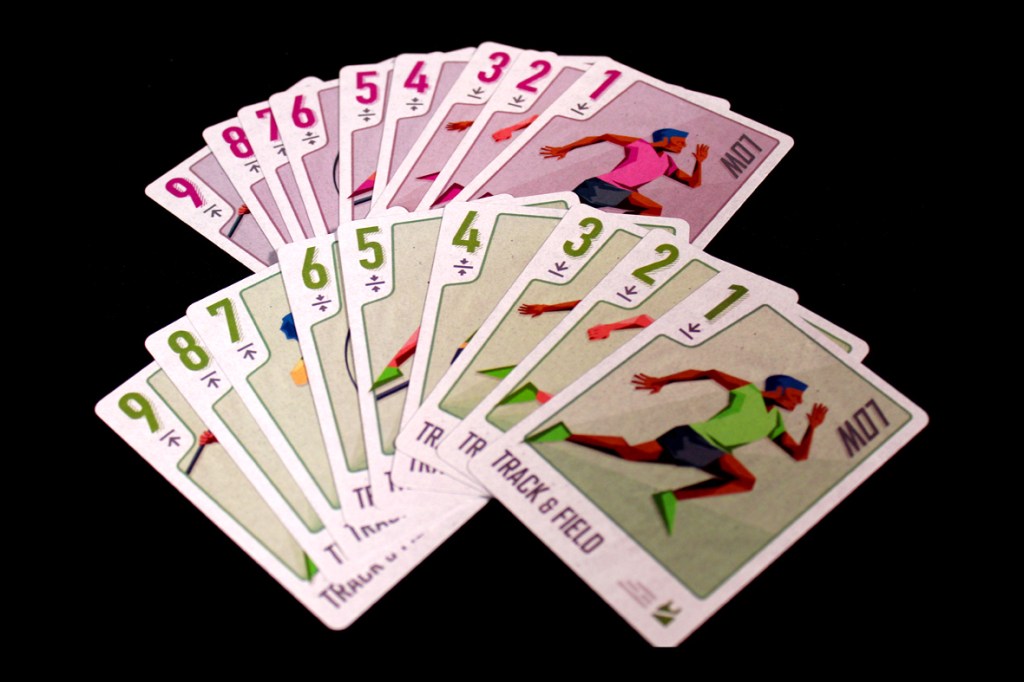A display of cards from the game Championland: Track & Field, featuring various athletes in action poses and numeric values. The cards are arranged in a fanned layout on a black background.