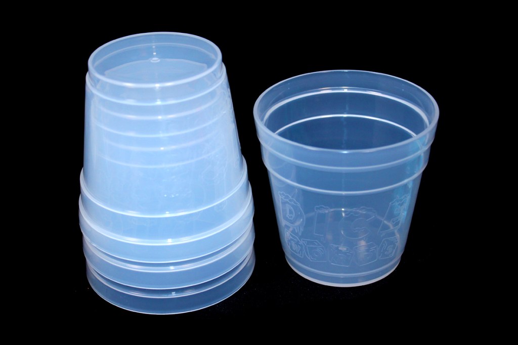 A set of transparent plastic cups stacked together, with one cup on its side displaying the 'Dice Words' logo.