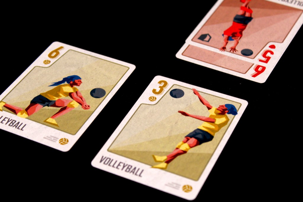 Illustration of two volleyball cards from the game Championland: Volleyball, featuring a player serving and another preparing to return the ball, with card numbers 6 and 3 displayed.