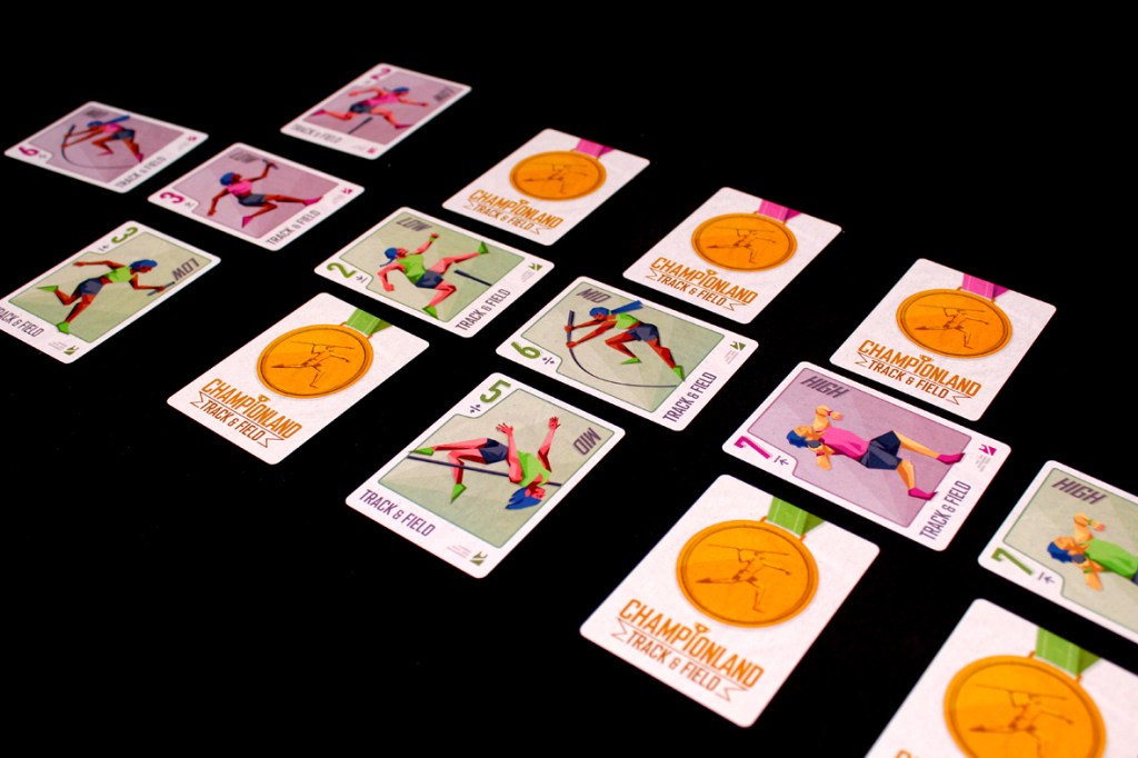 A layout of cards from the game Championland: Track & Field, featuring athletes and event cards, alongside golden medals, on a black background.