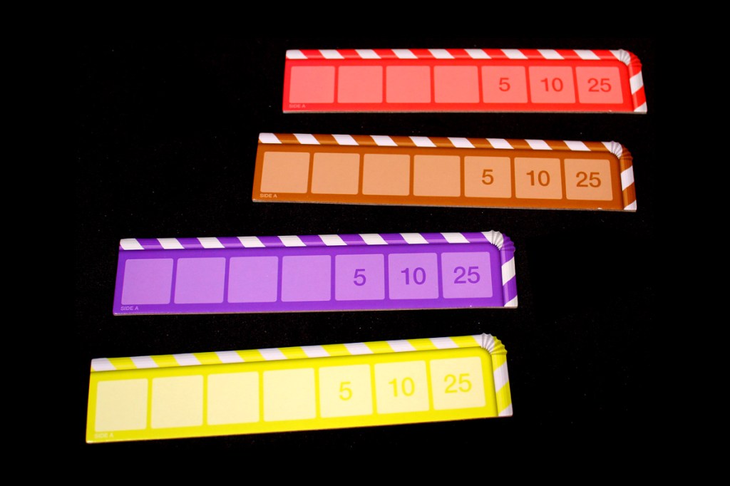 Four scoring boards for the game Dice Words, featuring different colors and point values of 5, 10, and 25.