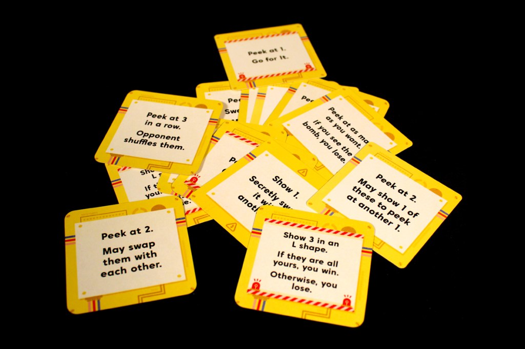 A collection of yellow action cards from the board game Bombastic, displaying various game instructions and effects on a black background.