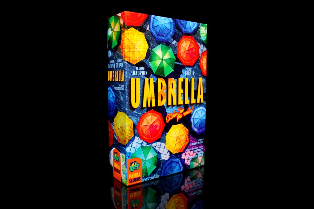 Box cover of the board game 'Umbrella', featuring a colorful design of umbrellas and the title in bold yellow letters.