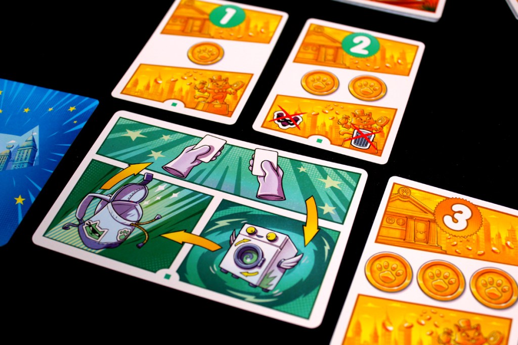 A close-up view of game cards from the Super Meow board game, featuring illustrated icons and instructions, with a colorful design set against a black background.