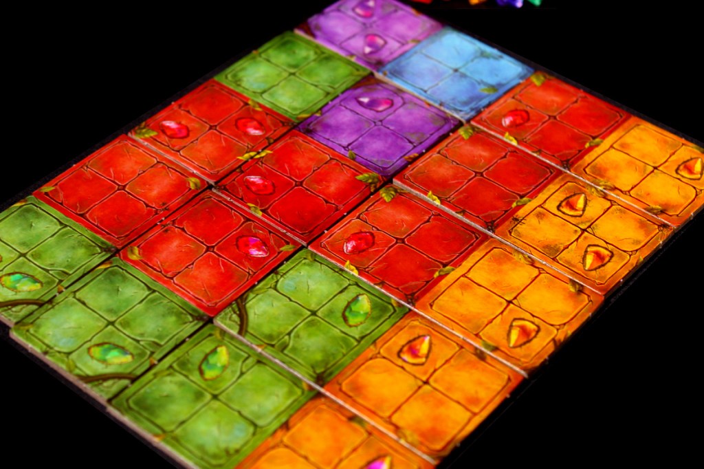 A close-up view of colorful game tiles arranged in a grid pattern, featuring various gem designs on each tile.