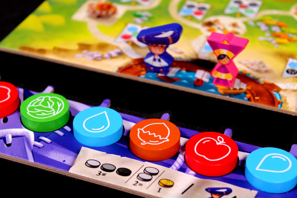 A close-up of a board game featuring colorful tokens in red, green, blue, and orange, with a game board depicting characters and locations in the background.