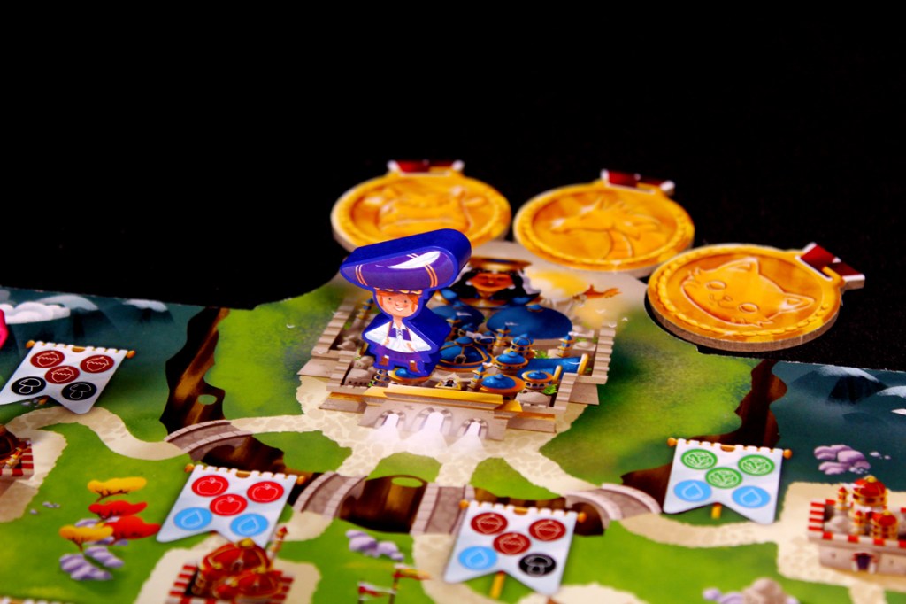Close-up of a colorful game board featuring a character in a blue outfit standing on a castle-like structure, surrounded by colorful flags and gold coins.