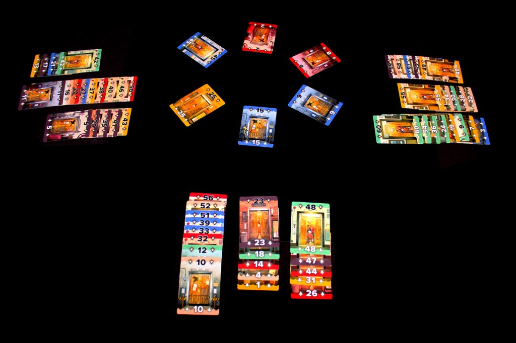 A collection of colorful gaming cards arranged on a dark surface, showing various numbers and designs.