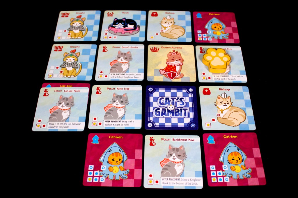A tabletop game board featuring various cat-themed game cards, including a Knight, Rook, Bishop, and Cat-ken cards, arranged on a colorful grid with the title 'CAT'S GAMBIT' prominently displayed in the center.