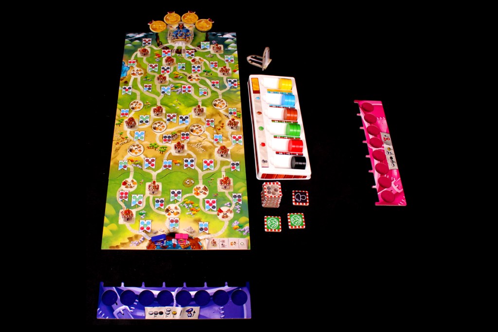 A colorful board game layout featuring a winding path, various game pieces, dice, and player tokens, set against a black background.