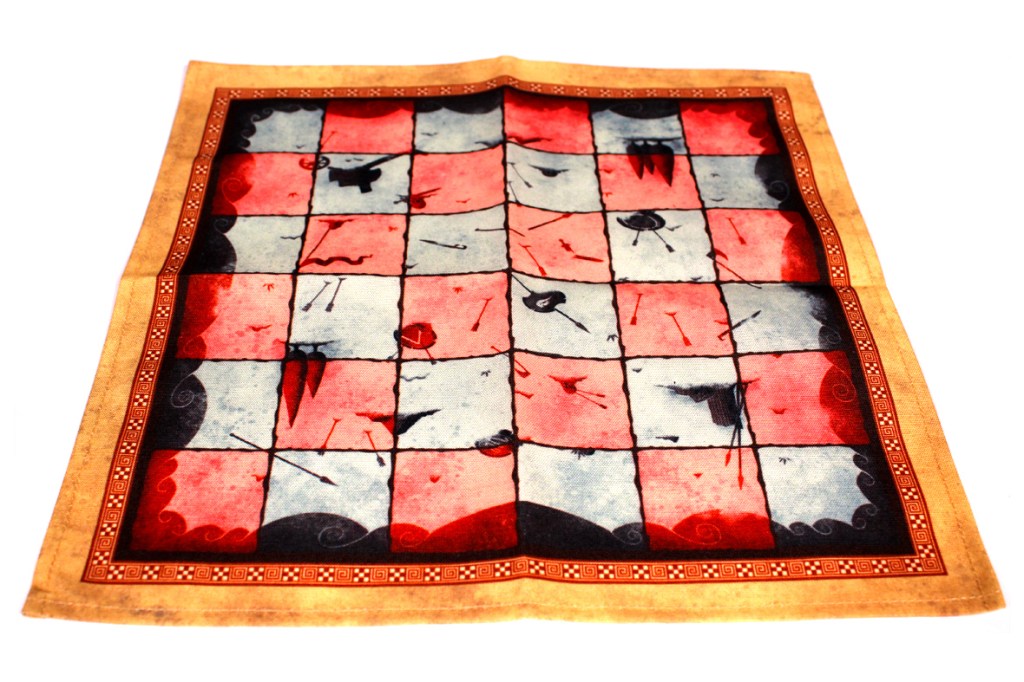 A colorful checkerboard-like fabric with red and gray squares, featuring abstract designs and patterns.