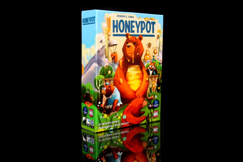A close-up of the board game box titled 'Honeypot' by Joseph Z. Chen, featuring colorful illustrations of bears and honey, with details of gameplay and age ratings visible.
