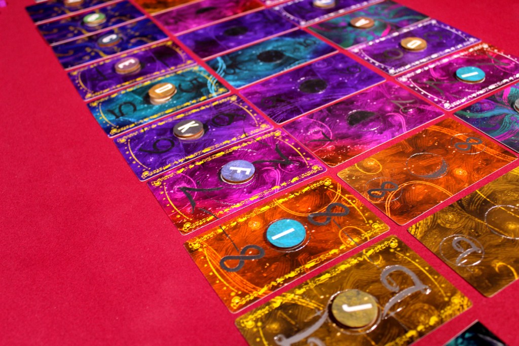 A colorful arrangement of game cards featuring various numbers and letters on a red background.