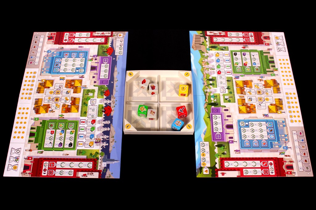 A tabletop board game setup featuring multiple player boards with colorful designs, sections for resources, and dice in the center.